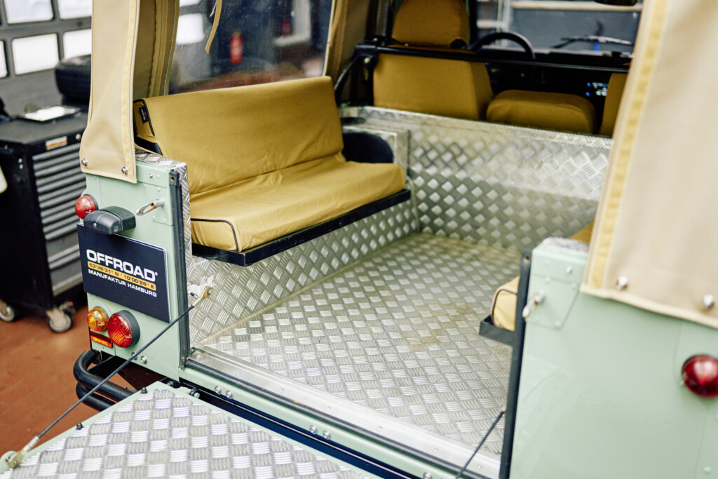 Innenraum des Defender 90 mit Canvas-Sitzbezügen und Riffelblech-Boden