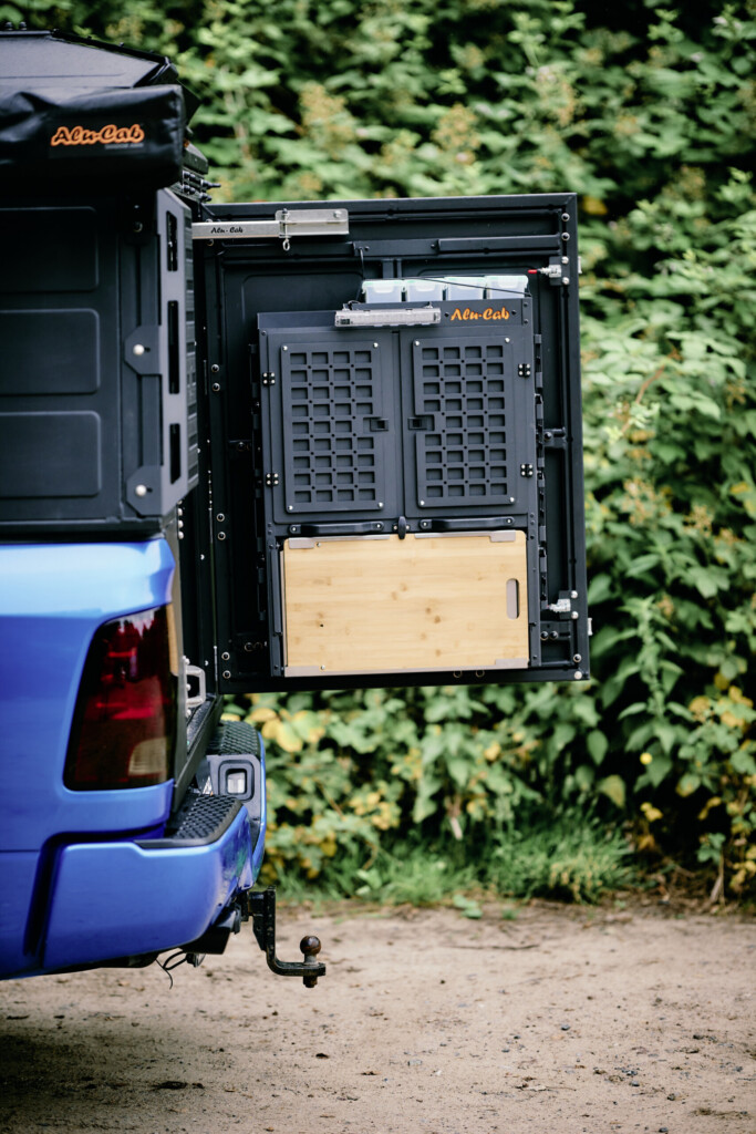 Folded-out kitchen module with bamboo worktop on the tailgate of the Alu-Cab ModCAP conversion