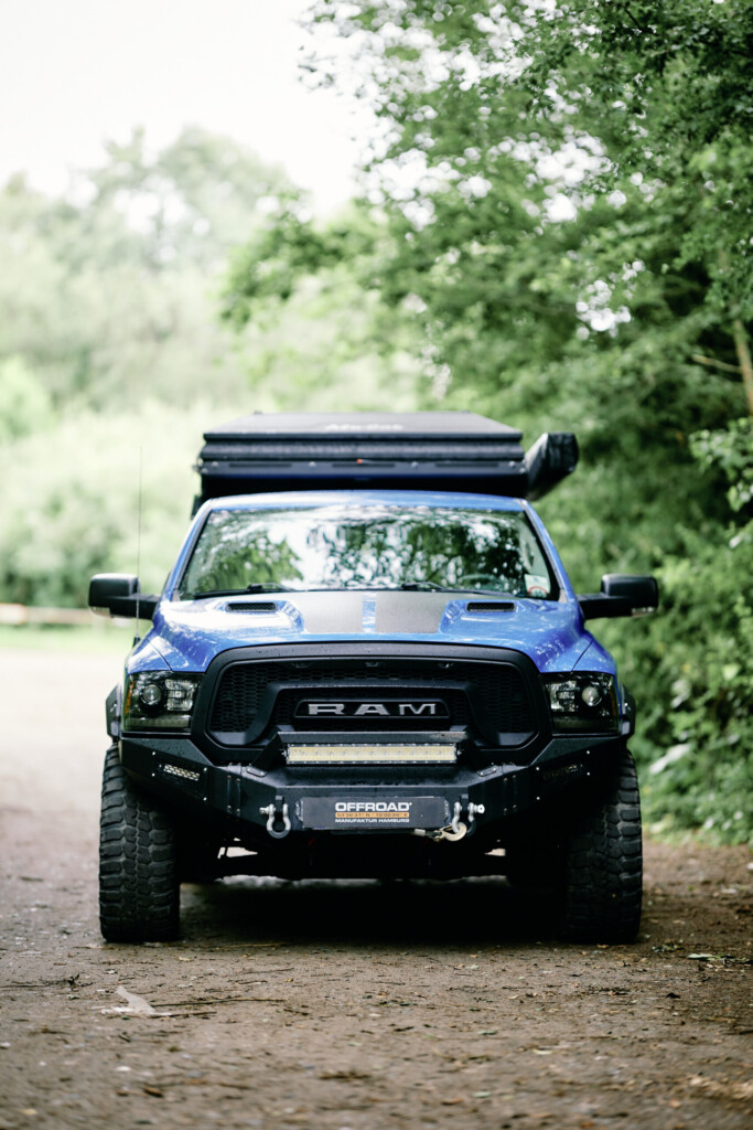 Blue Dodge RAM 1500 with Alu-Cab ModCAP conversion and OFFROAD front bumper, front view