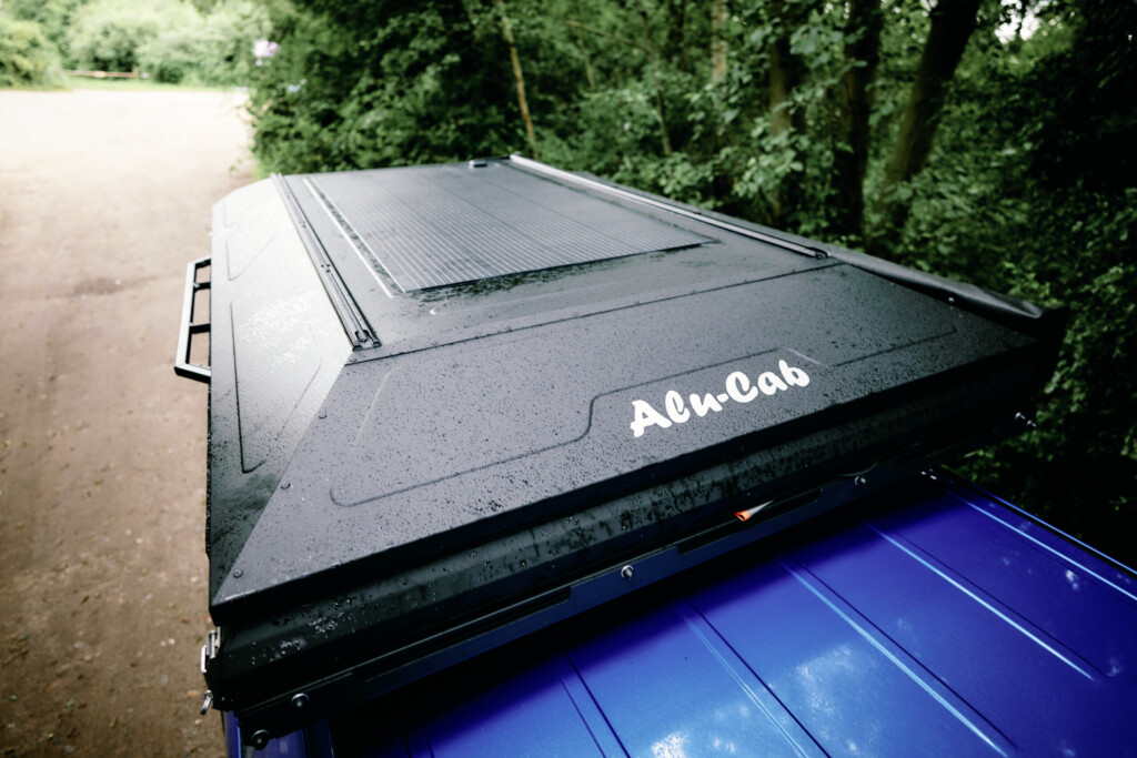 Alu-Cab ModCAP pop-top roof with integrated solar panel, top view above the bed of the Dodge RAM 1500
