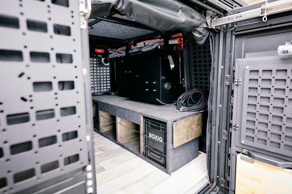 Interior of the Dodge RAM 1500 camper conversion with BOXIO modules and storage